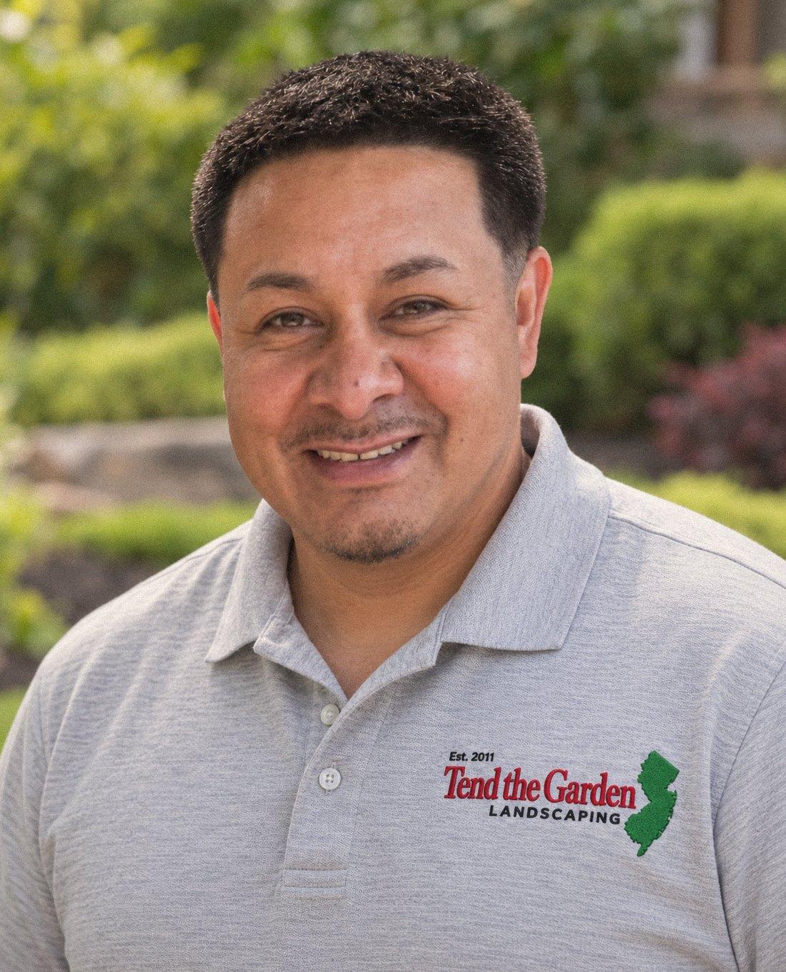 Sergio Portobanco, owner of Tend the Garden, in a gray company polo